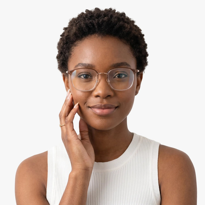 The Eydology Aubrie series of light brown gold frames accentuate a woman's graceful unique charm.