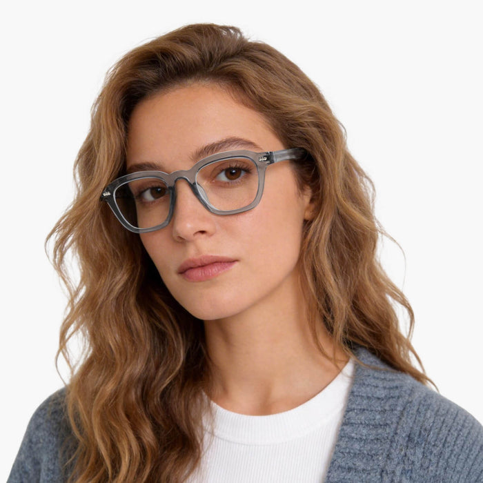 The gray square frames from the Eydology Crystal series accentuate a woman's composure.