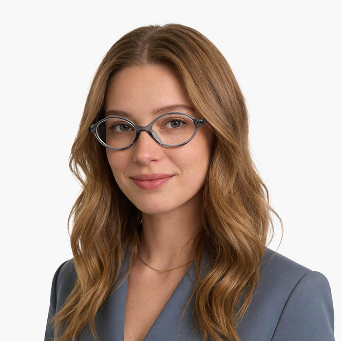 The Eydology Gage series of transparent grey frames accentuate a woman's gentle grace.