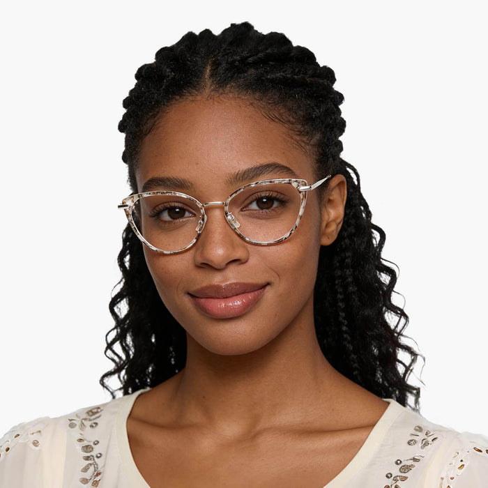 The Eydology Irene series of brown pearl silver frames accentuate a woman's elegant charm.
