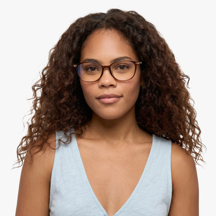 The Eydology Jax series of dark brown frames accentuate a woman's graceful unique charm.