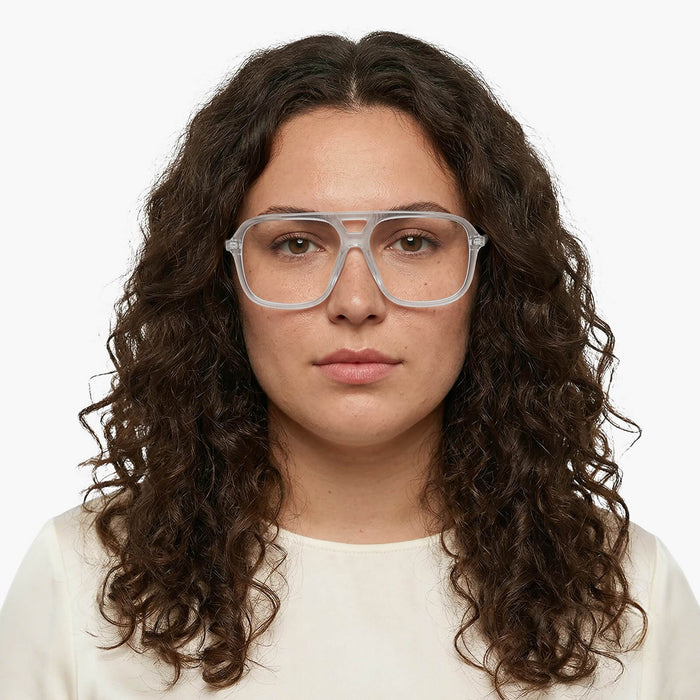 The Eydology Berkley series of transparent grey aviator frames accentuate a woman's calm stylish grace.